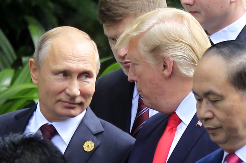 The Associated Press TRUMP AND PUTIN: Russian President Vladimir Putin, left, and U.S. President Donald Trump talk as they arrive for the family photo session Saturday during the Asia-Pacific Economic Cooperation Summit in Danang, Vietnam. President Trump stood before a summit of Asian leaders keen on regional trade pacts and delivered a roaring "America first" message Friday, denouncing China for unfair trade practices just a day after he had heaped praise on President Xi Jinping in Beijing.