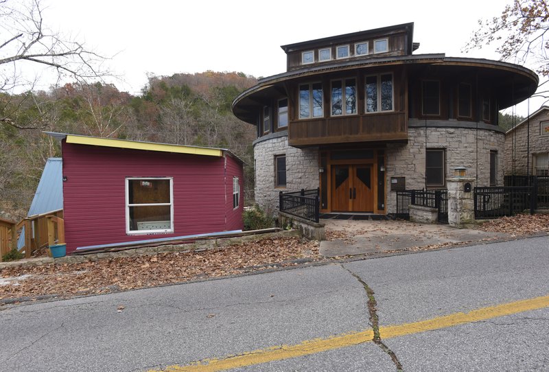 A lawsuit claims the addition to a home (left) has ruined the visual ambiance, historical value and view of a round stone house (right) in Eureka Springs. Twyla Pease of Iowa, owner of the round house, seeks to have the addition torn down or be paid $300,000 in damages.
