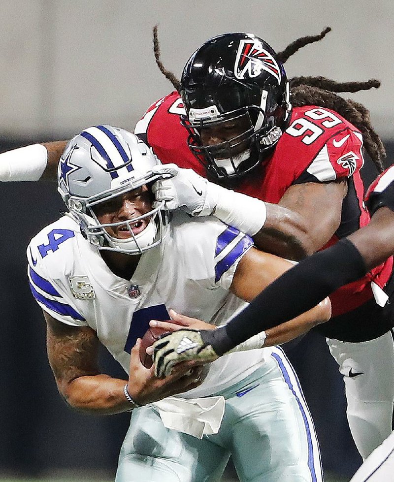 Falcons defensive end Adrian Clayborn sacks Dallas Cowboys quarterback Dak Prescott during the first half of their game Sunday in Atlanta. The Falcons won 27-7 as Clayborn’s six sacks matched the second-most in NFL history.