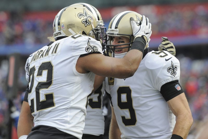 New Orleans Saints running back Mark Ingram (22) celebrates with quarterback Drew Brees (9) after Brees rushed for a touchdown during the second half of an NFL football game against thre Buffalo Bills, Sunday, Nov. 12, 2017, in Orchard Park, N.Y. 