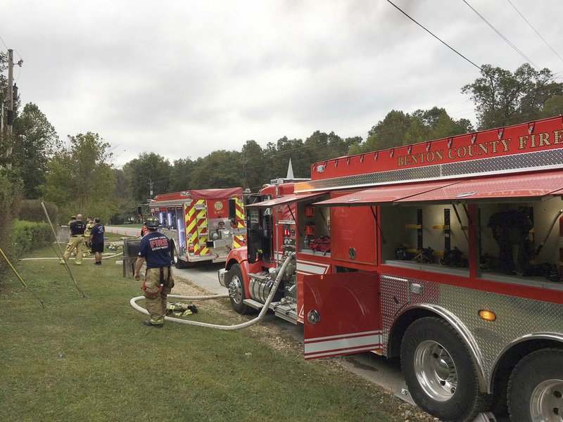 Firefighters from the Hickory Creek and Highway 94 East fire departments take part in a training burn Oct. 7 in the Monte Ne area. Benton County provides fire trucks to fire departments in the county to improve fire safety in rural areas.