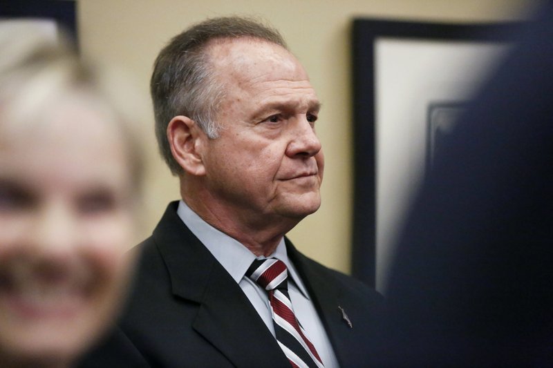 The Associated Press MOORE: Former Alabama Chief Justice and U.S. Senate candidate Roy Moore waits to speak the Vestavia Hills Public library, Saturday in Birmingham, Ala. According to a Thursday Washington Post story an Alabama woman said Moore made inappropriate advances and had sexual contact with her when she was 14. Moore is denying the allegations.