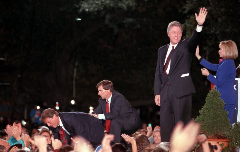 Arkansas Democrat-Gazette - 11/3/92 - President-elect Bill Clinton waves to the crowd packed into the Old State House grounds in Little Rock on election night 1992. Al Gore leans into the crowd at left, while Hillary Clinton waves at right.
