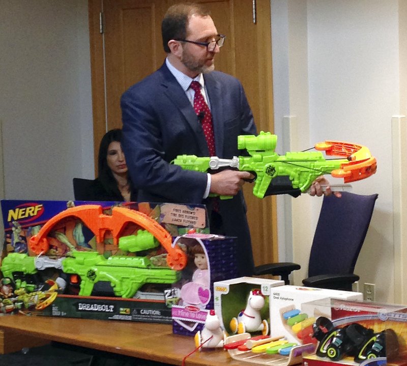 James Swartz, director of World Against Toys Causing Harm, or W.A.T.C.H., displays Nerf's "Zombie Strike" crossbow during a news conference Tuesday, Nov. 14, 2017, in Boston, where the child safety group released its annual holiday list of the 10 most hazardous toys