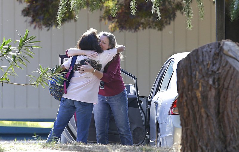 Two women embrace outside Rancho Tehama Elementary School, where a gunman opened fire Tuesday, Nov. 14, 2017, in Corning, Calif. 