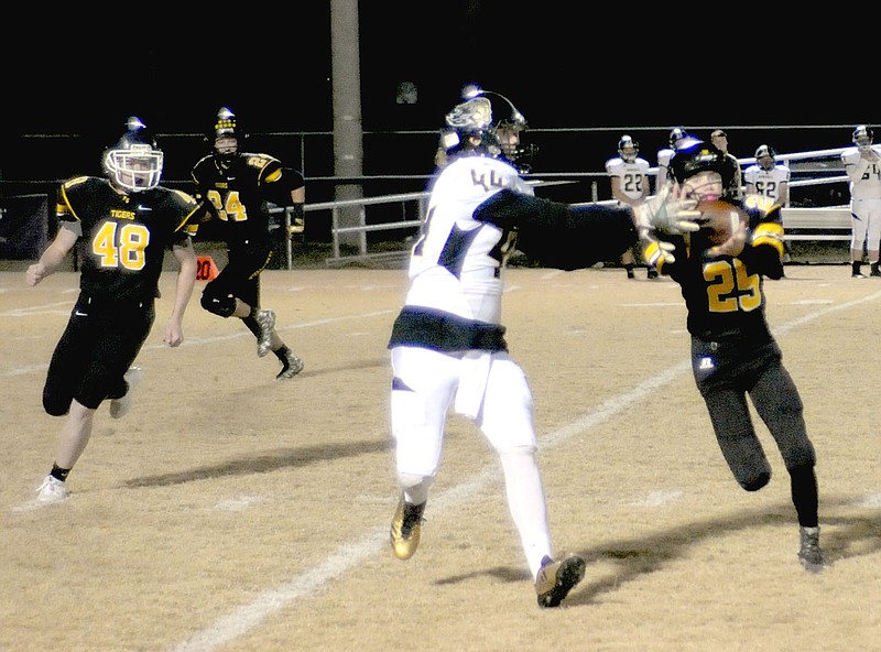 MARK HUMPHREY ENTERPRISE-LEADER Prairie Grove sophomore cornerback Cody Kruse (5-5, 108 pounds), who may have been the smallest player on the field, jumps a pass intended for Pottsville's Bradlee Denney. The Tigers recorded a 56-21 first-round playoff victory over Pottsville last week.