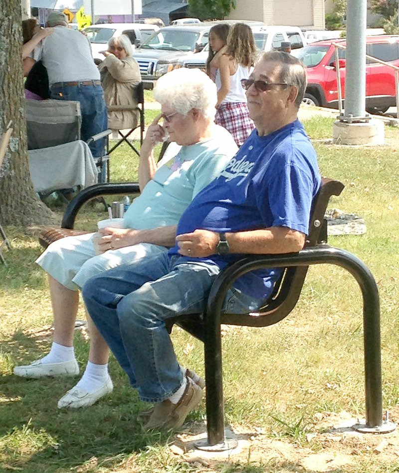 Photograph submitted El and Judy Orwig of Rogers enjoyed the sunshine and the third bench donated by the Pea Ridge Lions Club during the recent Pea Ridge Intermediate School "Picnic with the Grandparents." Two other benches have been donated by the Pea Ridge Lions Club and placed at the Veteran's Memorial in downtown Pea Ridge.