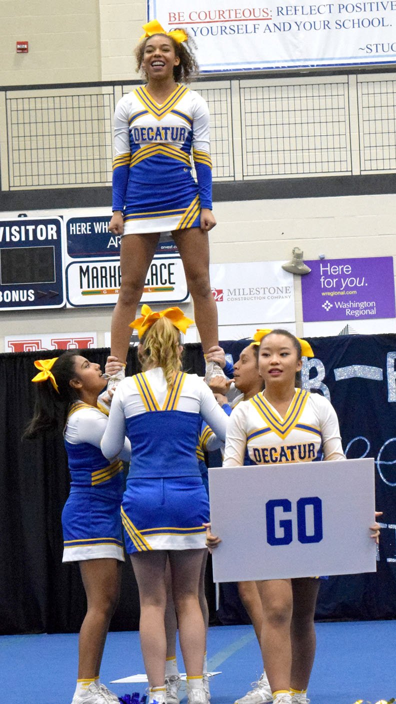 Photo by Mike Eckels With Jazmine Godiness (left), Alexis Patterson, Heidi Rubi and Kaitlyn Smith (hidden in back) forming the base, flyer Desi Meek is lifted into a half-elevator stunt while Emmy Lee helped lead the cheer during the Har-Ber Invitational Cheer competition in the gym at Har-Ber High School in Springdale Nov. 4.