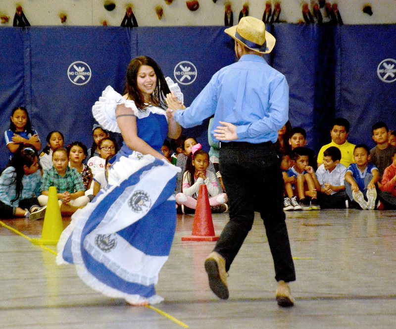 Janelle Jessen/Herald-Leader Mariana Portillo and Miguel Miranda, both John Brown University students, demonstrated a traditional dance from El Salvador during the Hispanic Heritage Night at Southside Elementary School on Friday.