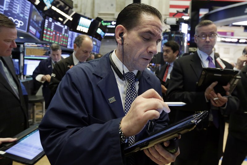 Trader Tommy Kalikas works on the floor of the New York Stock Exchange, Tuesday, Nov. 14, 2017. Stocks are opening lower on Wall Street as technology companies, banks and retailers sink. (AP Photo/Richard Drew)