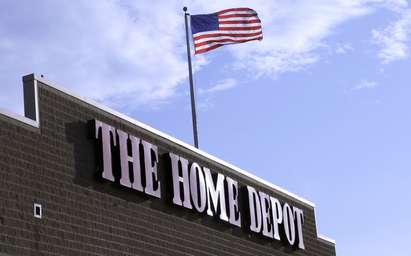 FILE - In this Wednesday, May 18, 2016, file photo, an American flag flies over a Home Depot store location in Bellingham, Mass. (AP Photo/Steven Senne, File)