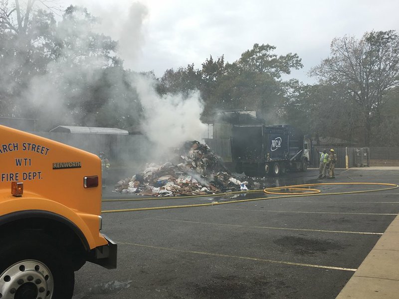 A garbage truck dumps its load that caught fire in the 14000 block of Arch Street in Pulaski County on Wednesday, Nov. 15, 2017.
