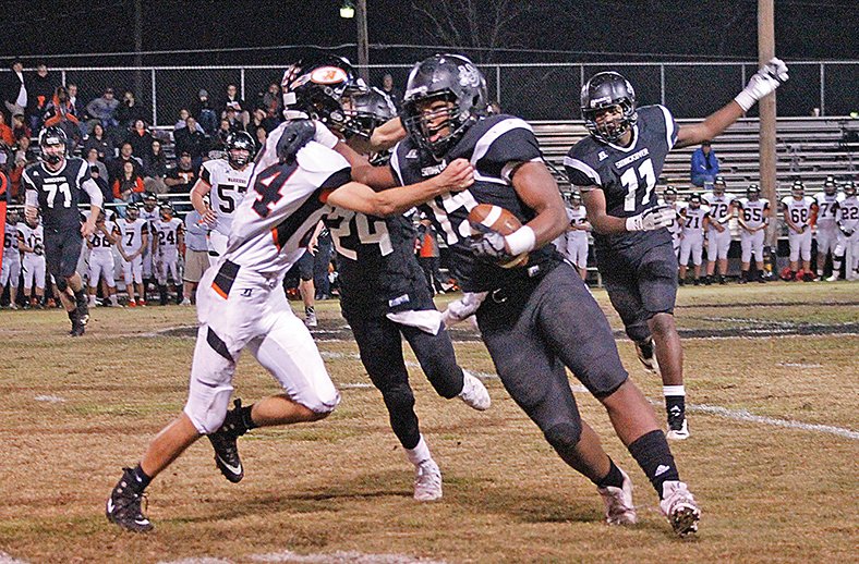 Kate Fields/News-Times Smackover's Damarous White (15) tries to fend off a Lamar defender with the aid of George Williams (24) during their clash in the opening round of the 3A playoffs last week in Smackover. On Friday, the Bucks will face Mayflower in the second round with a berth in the state quarterfinals at stake.