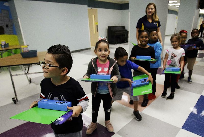 Puerto Rican pupils head to their classrooms Tuesday after they were given school supplies and books at Riverdale Elementary School in Orlando, Fla. 