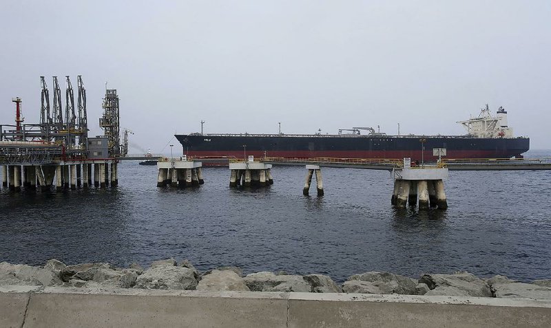 An oil tanker approaches a jetty at an oil facility in the United Arab Emirates in this file photo. Oil will continue growing as a source of energy for more than two decades, with the U.S. set to become the undisputed leader in oil and gas markets, the International Energy Agency said Tuesday.  