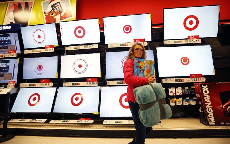 A customer shops for flat-screen televisions in a Target store in South Portland, Maine. Despite a drop in third-quarter profits, Target’s chief executive said the retailer is entering the Christmas season with “lots of confidence.” 