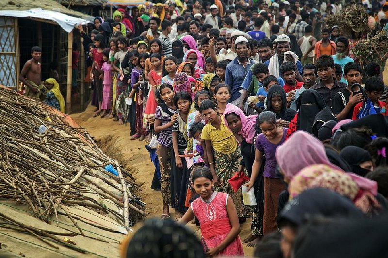 Rohingya Muslims wait for aid Wednesday at a refugee camp in Ukhiya, Bangladesh. 