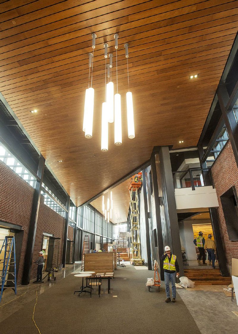 Workers finish up construction inside the new Tyson Foods building in downtown Springdale on Nov. 8. The facility on East Emma Avenue includes the former Tyson headquarters and the Brown Hatchery building. 