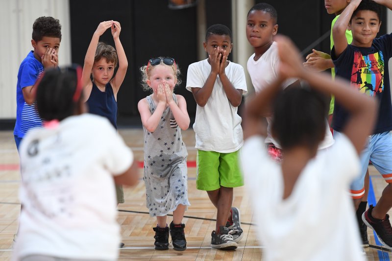 NWA Democrat-Gazette/J.T. WAMPLER Children play a resource-based game at the Summer Fun4Kids Camp in June at the Yvonne Richardson Center in Fayetteville. The program is designed to impact the lives of youth through a variety of activities focusing on health and fitness, nature, outdoors and the arts.