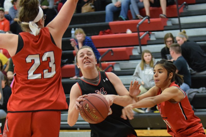 RICK PECKSPECIAL TO MCDONALD COUNTY PRESS Samantha Frazier gets fouled by Alexia Estrada before help from Mollie Milleson arrives during a girls' basketball scrimmage held Nov. 10 at McDonald County High School.