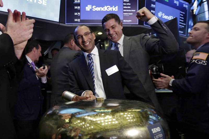 SendGrid CEO Sameer Dholakia, center, is cheered on by New York Stock Exchange President Tom Farley, right, as he rings a ceremonial bell as his company's IPO begins trading, Wednesday, Nov. 15, 2017.(AP Photo/Richard Drew)