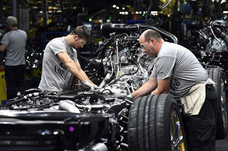 Workers assemble Ford pickups at a Louisville, Ky., plant in October. U.S. industrial production increased substantially in October, the Federal Reserve said Thursday, while the Labor Department said unemployment applications rose slightly last week. 
