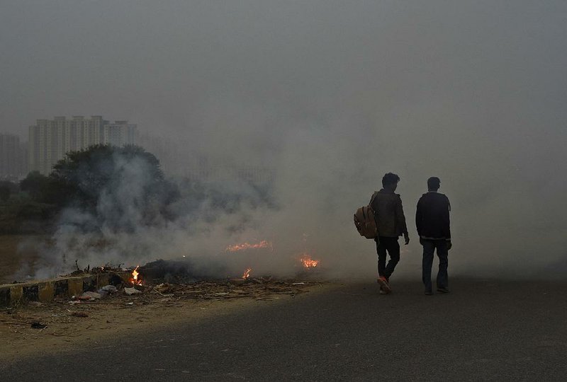 Smoke rises from garbage being burned on a roadside on the outskirts of New Delhi on Thursday, adding to the city’s regular, thick autumn smog arising from a variety of sources.