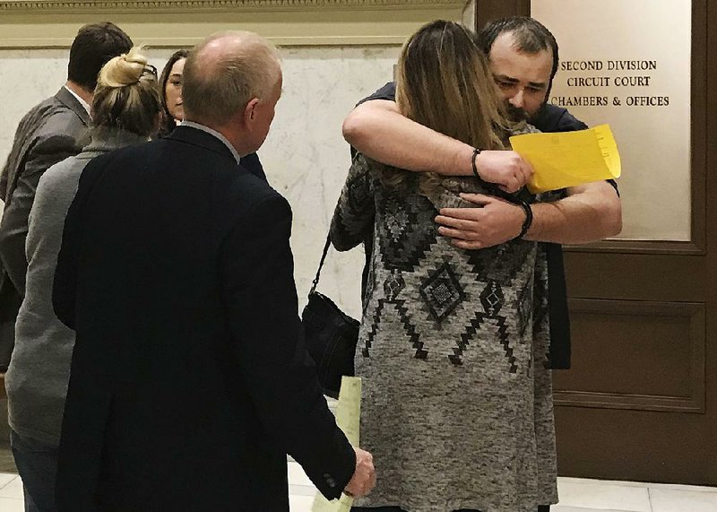 Michael Tate Reed hugs a family member Thursday in the Pulaski County Courthouse after being declared mentally unfit to stand trial in the destruction of Arkansas’ Ten Commandments monument.