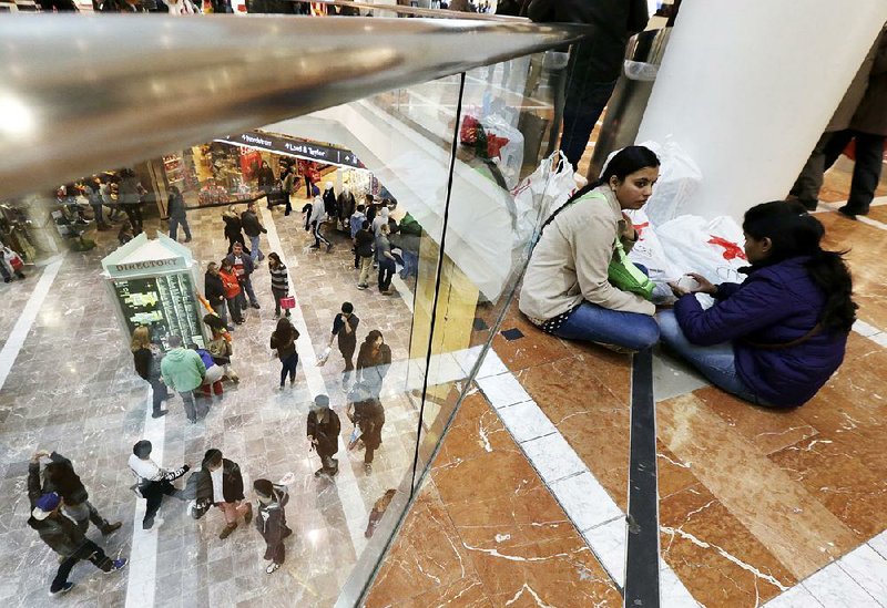 Shoppers take a break at a mall in Paramus, N.J. Real estate investment trusts have fallen behind the broader market this year, held back by store closures and other woes.