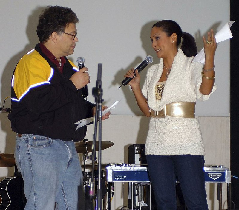 Then-comedian Al Franken and sports commentator Leeann Tweeden perform a comic skit at Forward Operating Base Marez in Mosul, Iraq, on Dec. 16, 2006, during the USO Sergeant Major of the Army’s 2006 Hope and Freedom Tour. Sen. Franken, D-Minn., apologized Thursday after Tweeden accused him of forcibly kissing her during the 2006 USO tour.