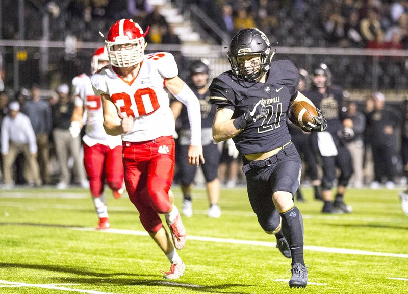 Special to NWA Democrat-Gazette/DAVID BEACH Bentonville High's Harrison Campbell (21) runs away from Cabot's Lucas Dalton Crumbly on his way to the end zone Friday at Tiger Stadium in Bentonville.