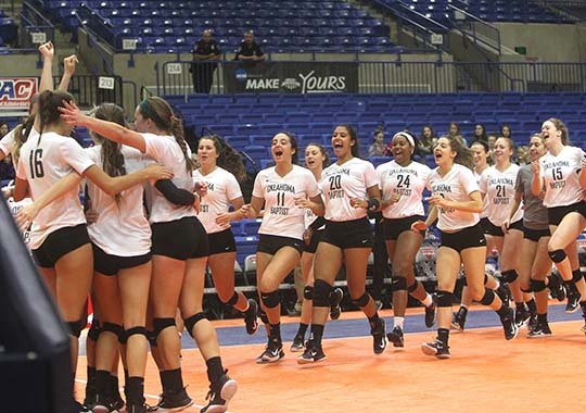 The Sentinel-Record/Richard Rasmussen SWEET VICTORY: Members of the Oklahoma Baptist volleyball team celebrate after beating Ouachita Baptist in the first round of the Great American Conference tournament Thursday at Bank of the Ozarks Arena. The Lady Bison will face Harding in the semifinals at 3:30 p.m. today.