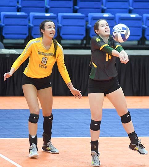 The Sentinel-Record/Mara Kuhn DIG THIS: Arkansas Tech's Madison Nagel (14) makes a return as Amanda Milnick (8) looks on against Southeastern Oklahoma State in the first round of the Great American Conference volleyball tournament Thursday at Bank of the Ozarks Arena. Nagel had a team-high nine digs in Arkansas Tech's 3-0 win.