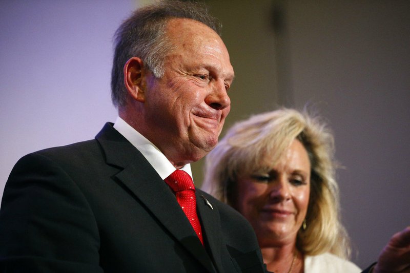 Former Alabama Chief Justice and U.S. Senate candidate Roy Moore speaks at a news conference Thursday, Nov. 16, 2017, in Birmingham, Ala., with his wife Kayla Moore, right. 