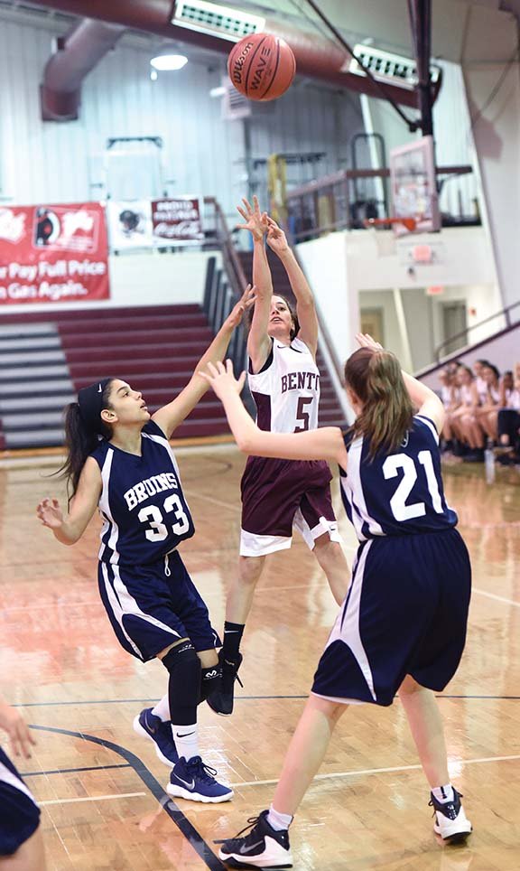 Benton Middle School seventh-grader Addison Davis shoots over a pair of Pulaski Academy defenders during the season opener at the Benton High School Arena on Nov. 14. The girls basketball team, which is coached by Maddie McRae, is part of the new seventh-grade athletic program in the Benton School District.