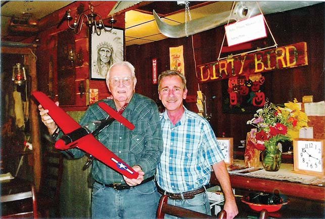 Jorli “J.C.” Sikes, 88, of Edgemont holds a model he made of a P-51 Mustang as he stands with Rob Bentley, owner of Bentley’s Restaurant in Greers Ferry. Sikes, an Air Force veteran, has made 14 of the World War II airplane models for the restaurant.
