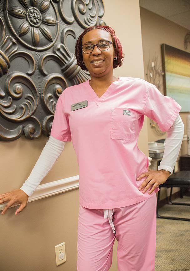 Ashanti Wallace stands in the Conway Obstetrics and Gynecology Clinic, where she works, at Conway Regional Medical Center. Wallace, a widowed mother of two, is enrolled in the Professional Adult College Education program. Wallace is the first recipient of a $10,000 scholarship through the newly formed CBC Women in Support of Hope Circle, which works with nonprofit organizations to help identify women who would benefit from the PACE program. WISH Circle also offers mentorships and supports women with prayer.