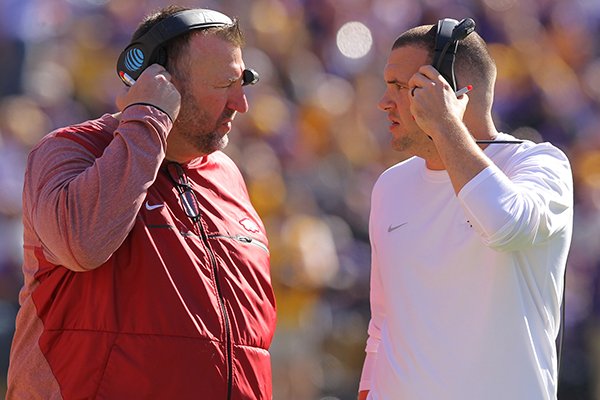 Arkansas coach Bret Bielema, left, talks with quality control coach Tanner Burns during a game against LSU on Saturday, Nov. 11, 2017, in Baton Rouge, La. 