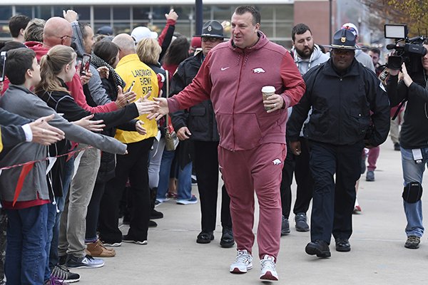 Arkansas coach Bret Bielema is greeted by fans as he enters the stadium to play Mississippi State during an NCAA college football game Saturday, Nov. 18, 2017 in Fayetteville. (AP Photo/Michael Woods)


