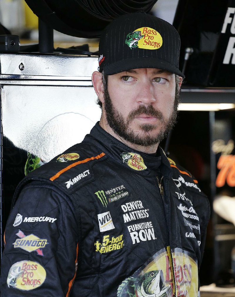 Martin Truex Jr. stands in the garage before practice for a NASCAR Cup Series auto race at Homestead-Miami Speedway in Homestead, Fla., Saturday, Nov. 18, 2017. 