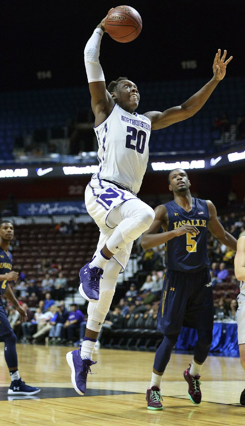 Northwestern’s Scottie Lindsey (20) drives in for a dunk in the second half against LaSalle on Saturday in Uncasville, Conn. Northwestern won 82-74. 