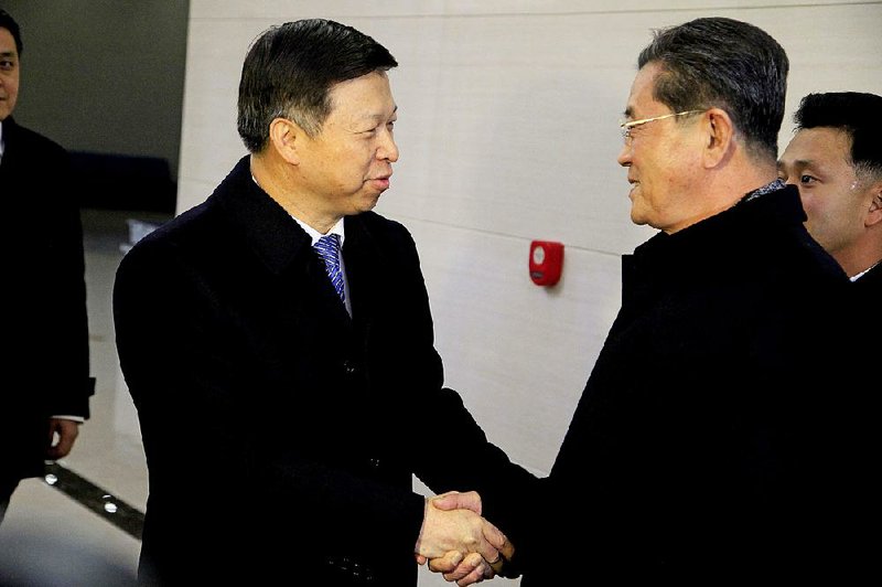 Song Tao (left), special envoy to President Xi Jinping, is greeted by North Korean official Ri Chang Gun in Pyongyang on Friday. 