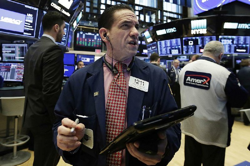 A trader works on the floor of the New York Stock Exchange on Friday, a day after the market rose to its biggest gain in two months.