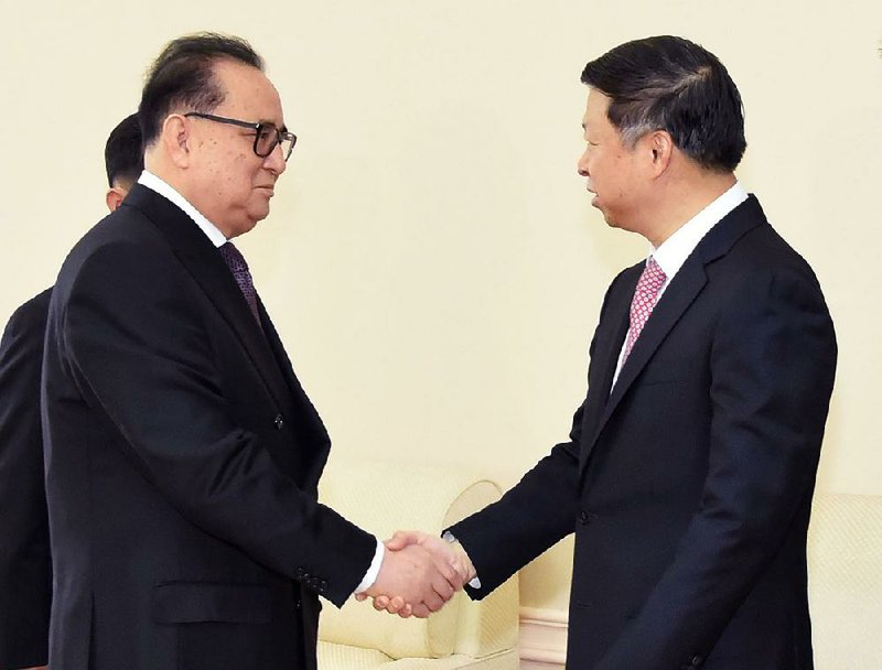 North Korean Foreign Ministry official Ri Su Yong (left) meets Saturday in Pyongyang with Chinese senior diplomat Song Tao. Media accounts said the two envoys discussed matters of mutual concern.