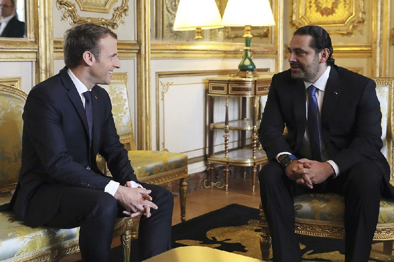 French President Emmanuel Macron (left) meets with Lebanese Prime Minister Saad Hariri at the Elysee palace Saturday in Paris.