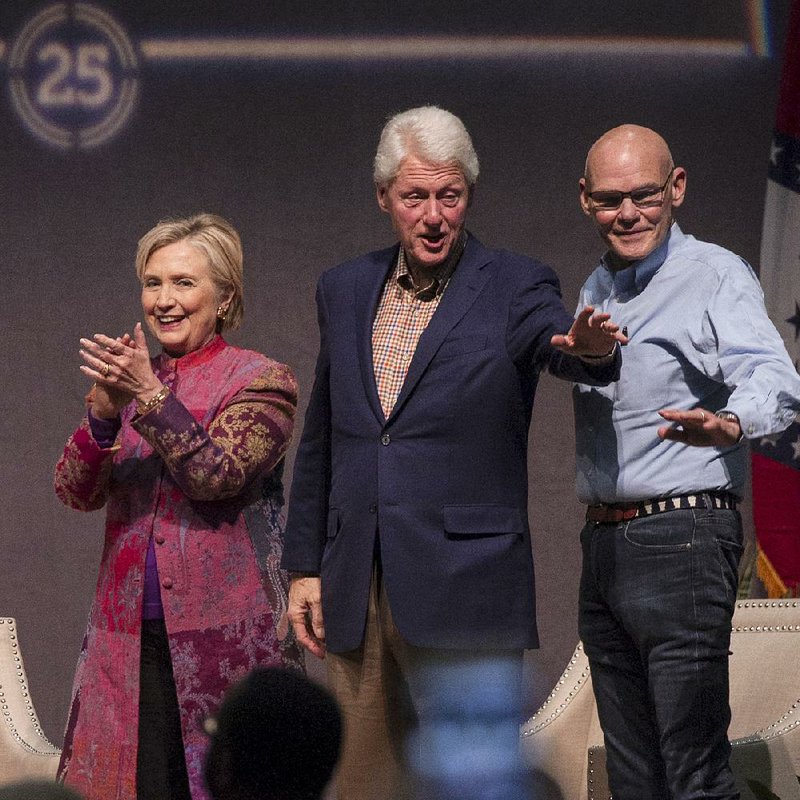 Hillary and Bill Clinton, along with moderator and longtime associate James Carville (right), greet the crowd Saturday evening at the Statehouse Convention Center in downtown Little Rock.