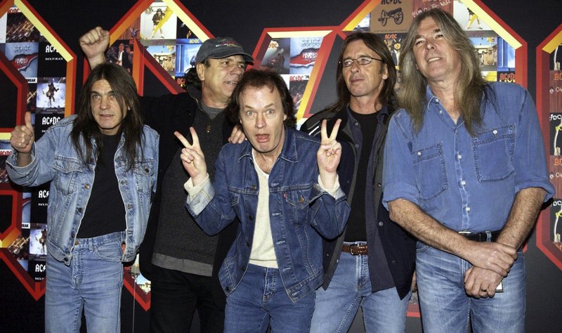 A March 3, 2003 file photo of from left: Malcolm Young, Brian Johnson, Angus Young, Phil Rudd and Cliff Williams from AC/DC posing for photographers at the Apollo Hammersmith in London. The band has announced, Saturday Nov. 18, 2017, that 64-year-old Young has died. 