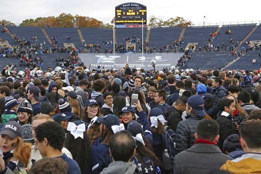 Yale students rush the field after their win against Harvard in an NCAA college football game on Saturday, Nov. 18, 2017 in New Haven, Conn. Yale won 24-3, securing the Bulldogs' first outright Ivy League championship in 37 years. (AP Photo/Gregory Payan)