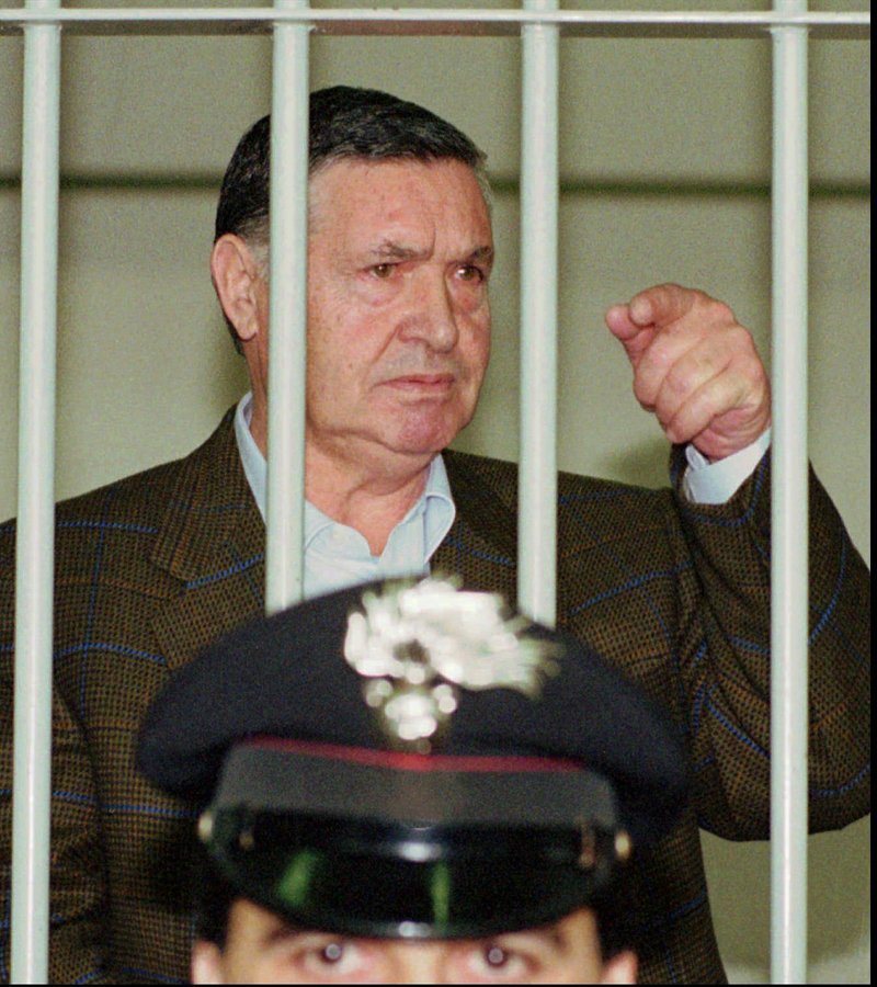 The Associated Press 'BOSS OF BOSSES': In this April 29, 1993, photo, Mafia "boss of bosses" Salvatore "Toto" Riina, is seen behind bars, during a trial in Rome. Italian media is reporting that Mafia 'boss of bosses' Salvatore 'Toto' Riina has died while serving multiple life sentences. He was 87. The justice ministry on Thursday had allowed his family a bedside visit at a hospital Parma shortly before his death. He had been placed in a medically induced coma after his health deteriorated following two recent surgeries.