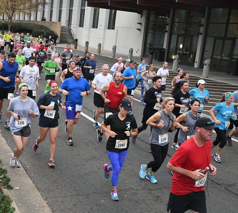 The Sentinel-Record/Mara Kuhn AND THEY'RE OFF: Runners begin the Spa 10K during the Spa Running Festival on Convention Boulevard Saturday morning.